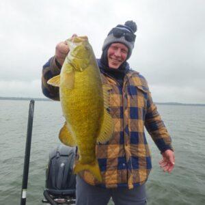 Randy with giant prespawn Presque Isle Smallmouth. Big Fat Bass Guide Service.