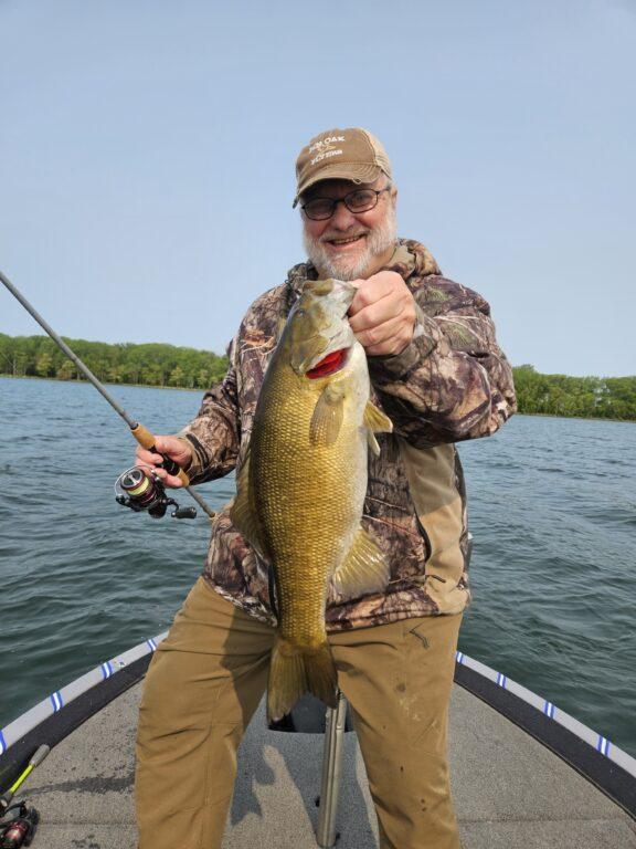 Client Gary with nice June Presque Isle Bay smallmouth with Big Fat Bass Guide Service.
