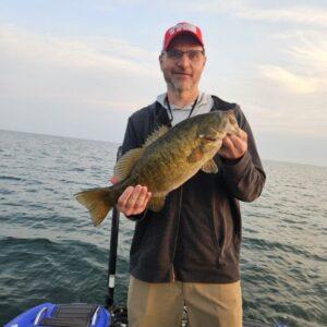 Client Brad with a big Lake Erie smallmouth bass with Big Fat Bass Guide Service