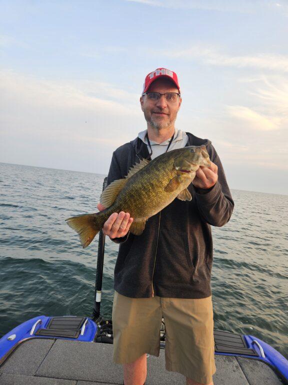 Client Brad with a big Lake Erie smallmouth bass with Big Fat Bass Guide Service