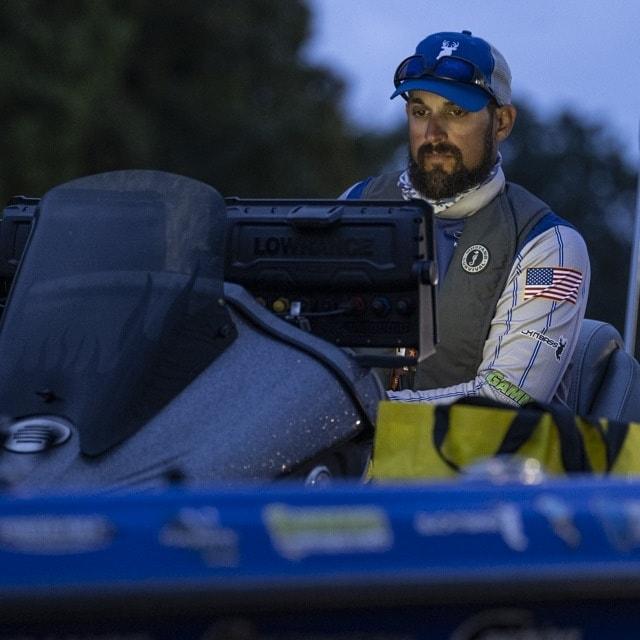 Destin DeMarion looking at his fishing electronics